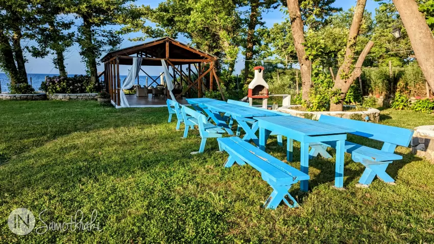 The corner with tables, barbecue, and gazebo