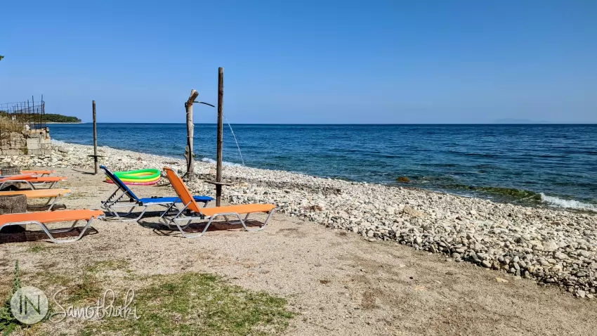 There are sun loungers on the beach.