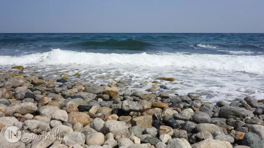 Stony beach and dark blue water