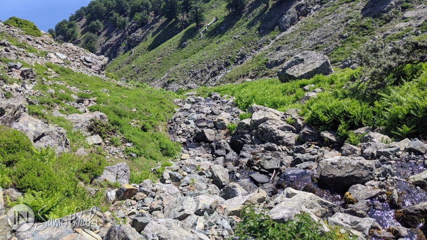The path descends into the river valley.