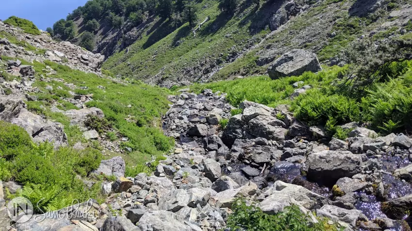 The path descends into the river valley.