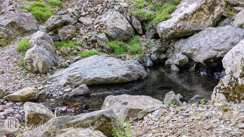 The trail crosses a mountain stream.