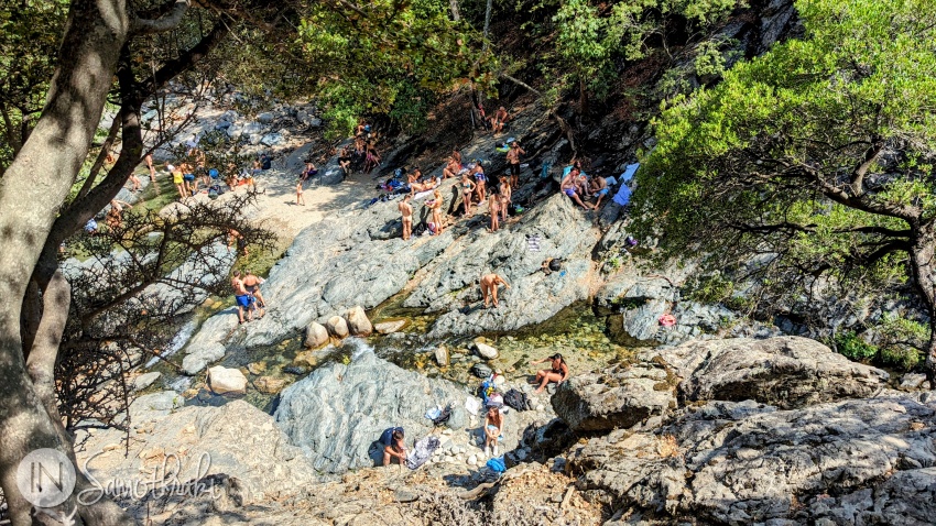 During the summer, the places around the waterfall are full of people.