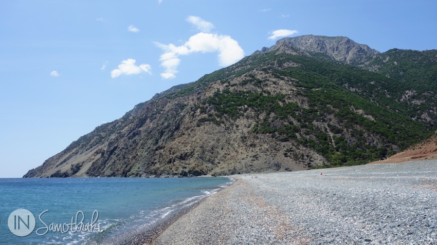 The mountain rises abruptly at one end of Kipos Beach