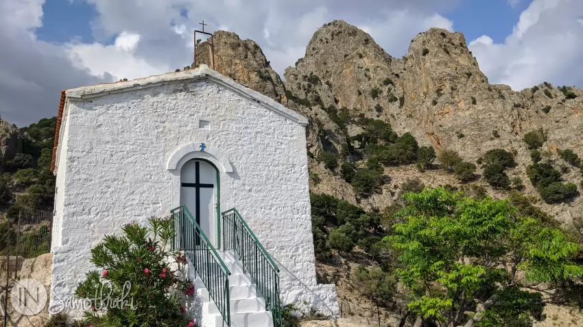 The mountains rise behind the church.