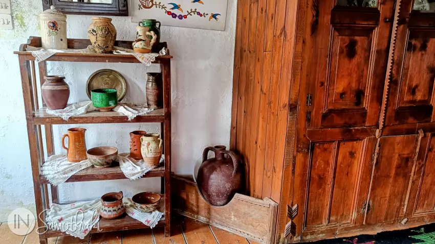 A water jar to the left of the wardrobe