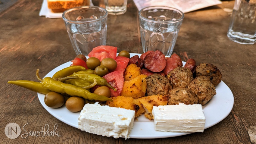 Glasses of tsipouro and mezedes at Karnagio cafe in Kamariotissa
